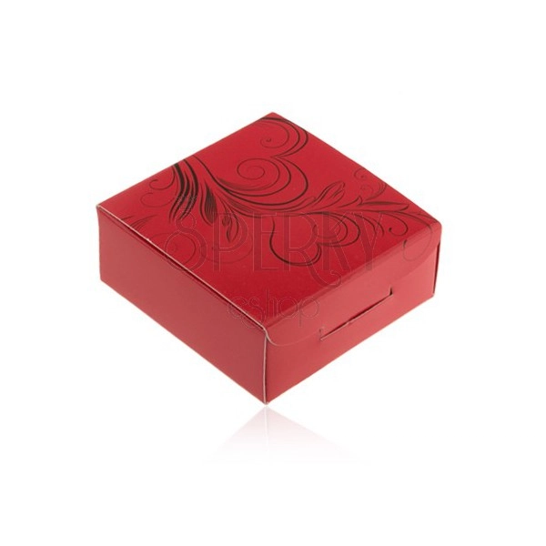 Červená krabička na prsten nebo náušnice, černé obrysy srdcí, lístky, spirály