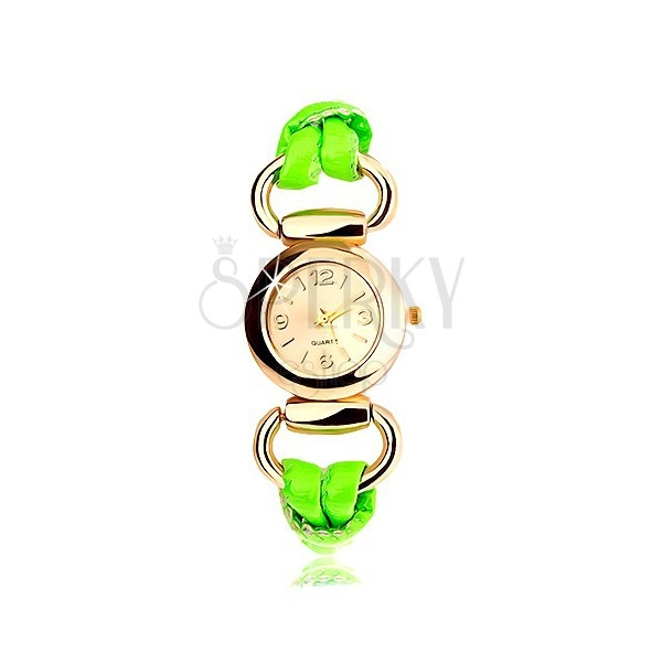 Analogové hodinky, kulatý ciferník zlaté barvy, latexový zelený řemínek
