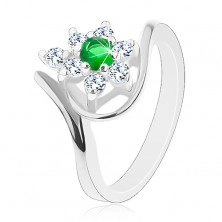 Třpytivý prsten ve stříbrné barvě, tmavě zelený kvítek s čirými lupínky