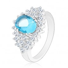 Třpytivý prsten se světle modrým oválným zirkonem, čirá zirkonová obruba