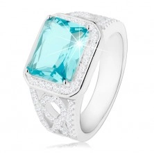 Stříbrný 925 prsten, ramena s ornamentem, světle modrý zirkon, čirá obruba