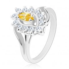 Třpytivý prsten ve stříbrném odstínu, žluté zrnko, čiré zirkonky