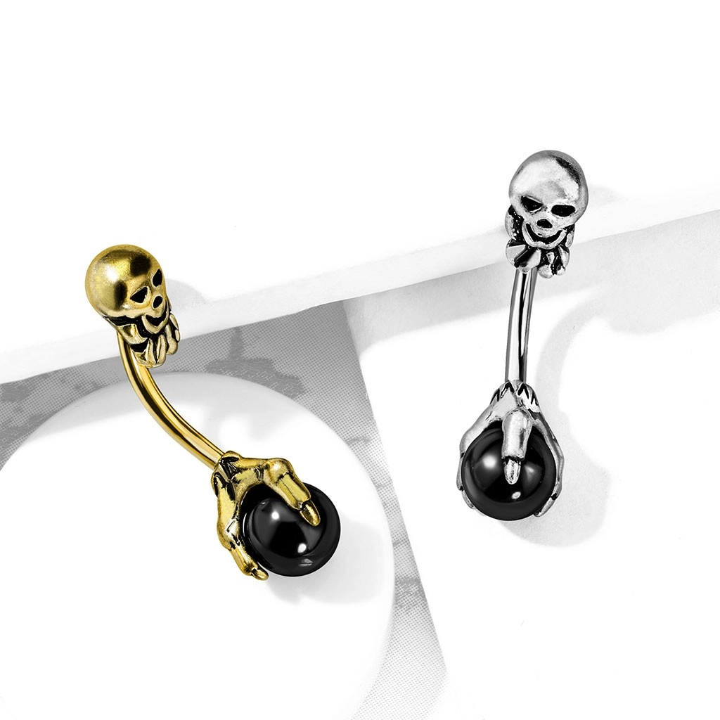 Ocelový piercing do pupíku ve starožitném vzhledu - lebka, černá kulička v drápech - Barva: Zlatá